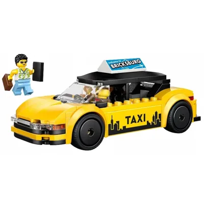A LEGO yellow taxi set with a mini-figure holding a briefcase and a mobile phone, featuring a \“Bricksburg\“ sign on the roof.