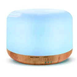A round essential oil diffuser with a light wood base and glowing blue top, featuring controls for mist, timer, and light settings.