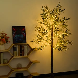 An artificial tree illuminated with warm white LED lights stands against a wall, creating a cozy decorative light source in a room.