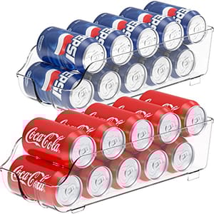 Two clear plastic can dispensers, each holding rows of beverage cans stacked horizontally with a curved dispensing area at the front.