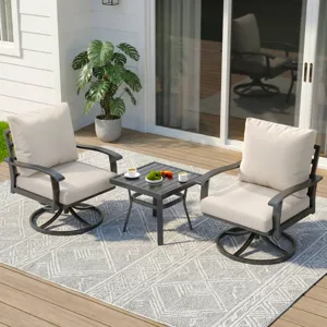 Outdoor patio set with two cushioned swivel chairs and a small black side table on a patterned rug, featuring cups and snacks. A potted plant is in the background.