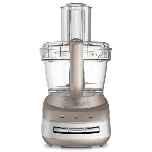 A metallic food processor with a clear plastic bowl and lid, featuring controls for low, high, and pulse settings.
