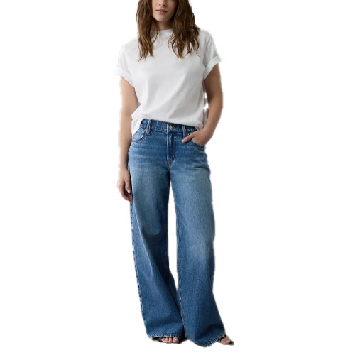 A person wearing a white t-shirt and wide-leg blue jeans.