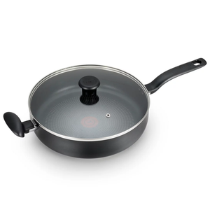 The T-Fal Jumbo Cooker is a large, nonstick pan with a long handle, side grip, and a glass lid with a steam vent. It features a textured cooking surface with a heat indicator for optimal cooking temperature.
