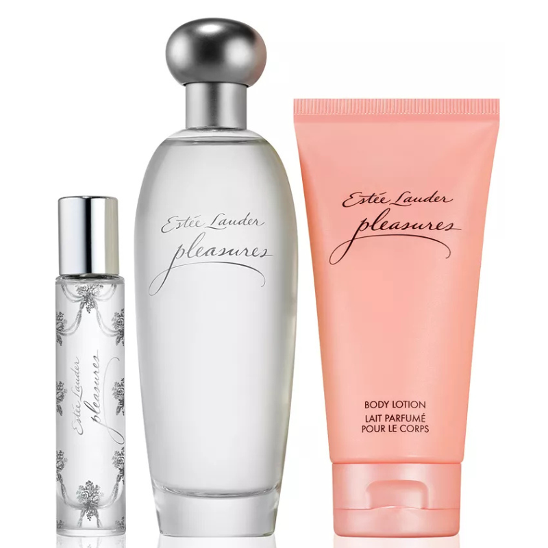 The Estée Lauder Pleasures Fragrance Set includes a perfume bottle, a travel-sized rollerball fragrance, and a body lotion, all featuring the Pleasures scent. The products are packaged in elegant, simple designs with a silver cap and a pink lotion tube.