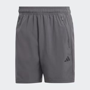 This is a pair of grey Adidas shorts with an elastic waistband, a zippered pocket on the right side, and the Adidas logo on the left hem.