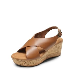 Brown leather wedge sandals feature a broad cross strap design, an adjustable ankle strap, and a cork-style platform heel.