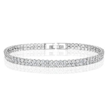 Silver tennis bracelet featuring a row of sparkly round gemstones, secured with a clasp.