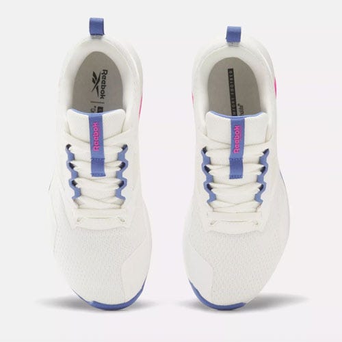 a pair of white reebok nanoflex sneakers with purple accents
