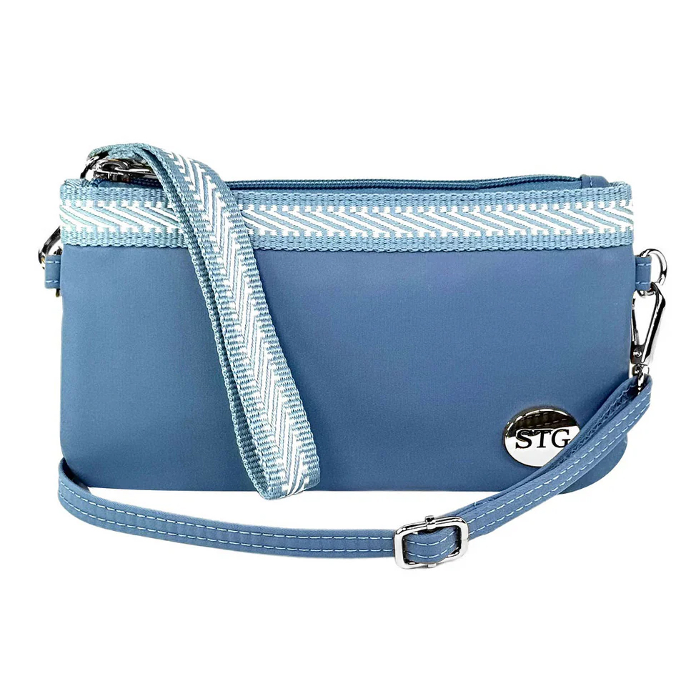 A blue crossbody bag with a removable strap and chevron-patterned trim. It features a silver \“STG\“ emblem.