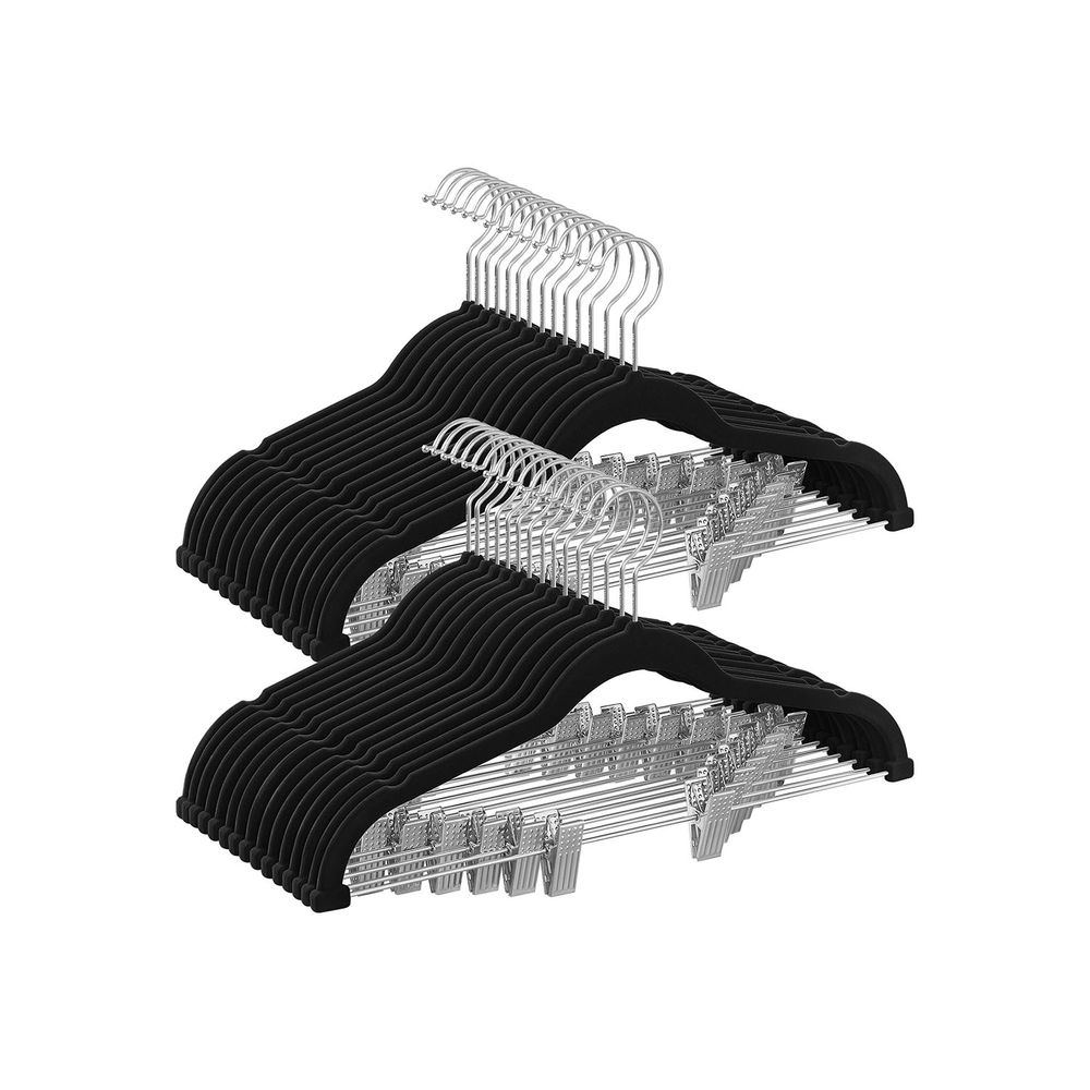 Two sets of black velvet non-slip clothes hangers with silver metal hooks are shown, featuring built-in pant clips for versatile garment hanging.