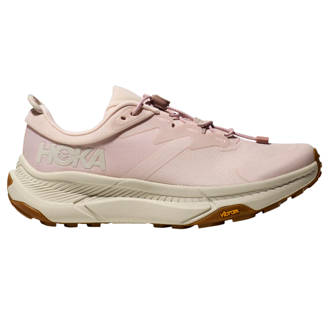 Light pink HOKA running shoe with Vibram sole, featuring a cushioned midsole and secure lacing system.