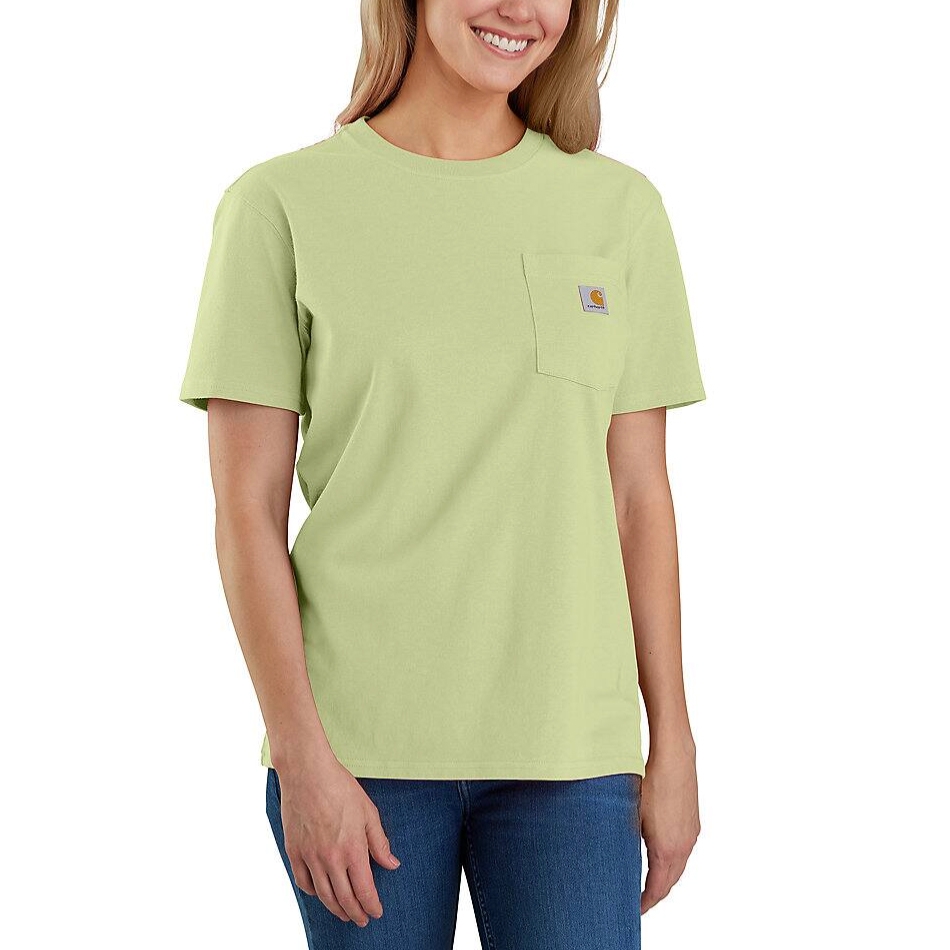 A woman is wearing a light green Carhartt T-shirt with a pocket logo on the chest, paired with blue jeans.