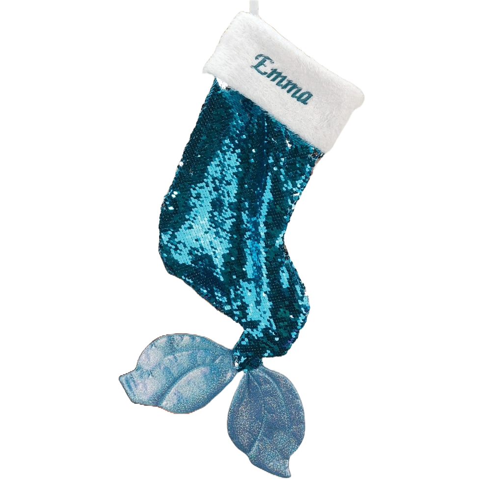 A turquoise sequined Christmas stocking shaped like a mermaid tail with a white cuff featuring the name \“Emma\“ embroidered on it.