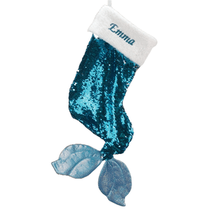 A turquoise sequined Christmas stocking shaped like a mermaid tail with a white cuff featuring the name \“Emma\“ embroidered on it.