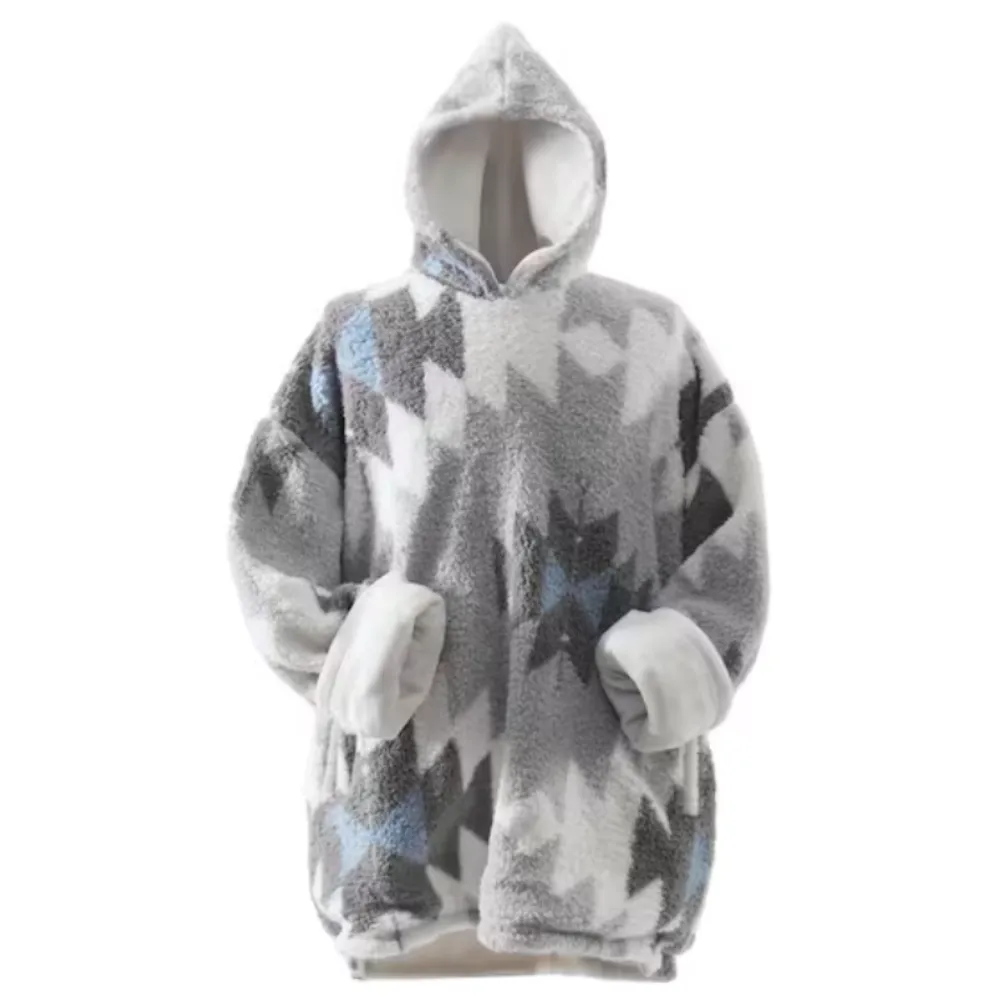 A cozy, oversized hooded blanket sweatshirt with a geometric pattern in shades of gray, white, and blue. It features large sleeves and a soft, plush lining.