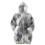 A cozy, oversized hooded blanket sweatshirt with a geometric pattern in shades of gray, white, and blue. It features large sleeves and a soft, plush lining.