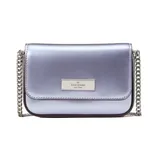Metallic lavender crossbody bag with a chain strap and a rectangular metal logo plate on the front.