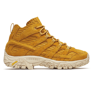 A mustard-yellow mid-top sneaker by Merrell featuring a rugged design, suede material, and a Vibram sole for traction and durability.
