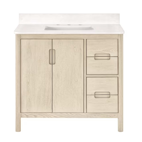 A light wood bathroom vanity with an integrated sink, featuring two doors and three drawers with metal handles.