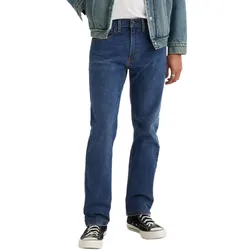 A person wearing straight-fit dark blue jeans, a light denim jacket, and black and white sneakers.