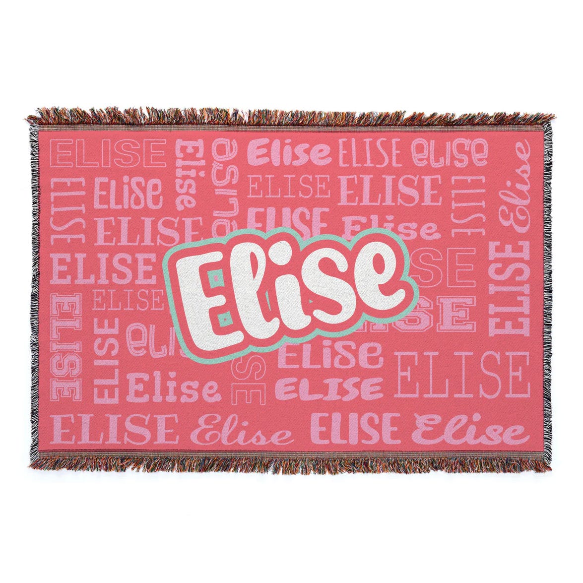 A woven blanket with fringed edges features the name \“Elise\“ in various fonts and sizes against a pink background.
