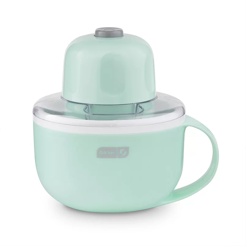 A mint green Dash electric citrus juicer with a clear top, featuring a handle for easy pouring.