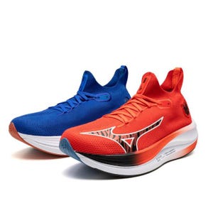 Brightly colored athletic running shoes, one blue and the other red with white and black details, featuring a high cushioned sole and a distinct logo on the side.