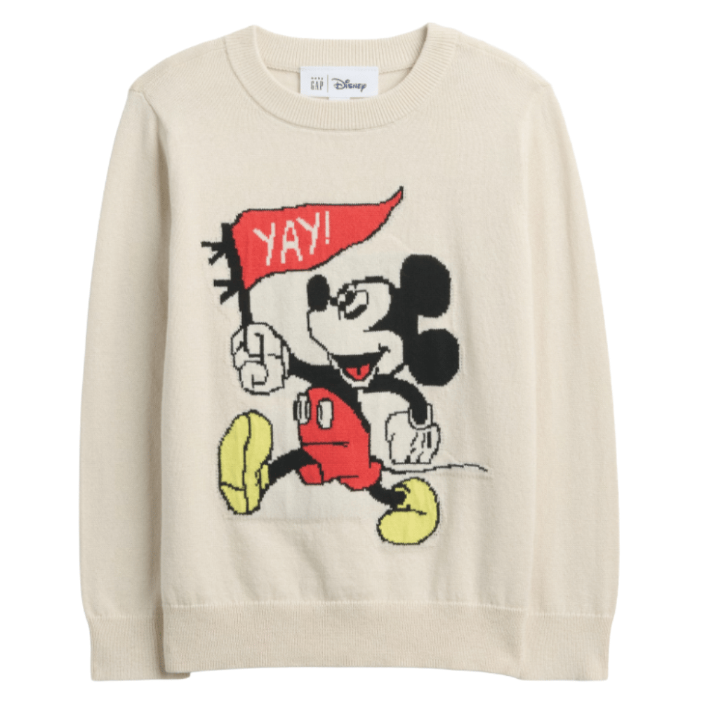 Cream sweater featuring a cartoon character with yellow shoes and red shorts, holding a flag that reads \“YAY!\“.