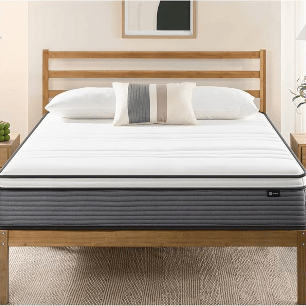 A neatly made bed with a white mattress and pillow on a wooden frame. The bed has a striped accent pillow, with a minimalist design suitable for a modern bedroom.