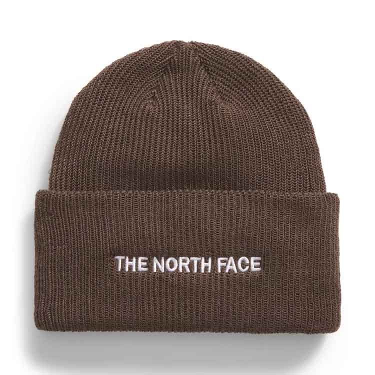 Brown knitted beanie with \“THE NORTH FACE\“ embroidered in white on the folded brim; designed for urban style and warmth.