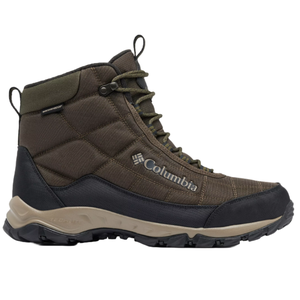 Columbia Men's Firecamp Boots are mid-height, waterproof boots featuring a brown quilted upper with reinforced toe and heel, green eyelets, and a durable, textured sole for traction. The Columbia logo is visible on the side.