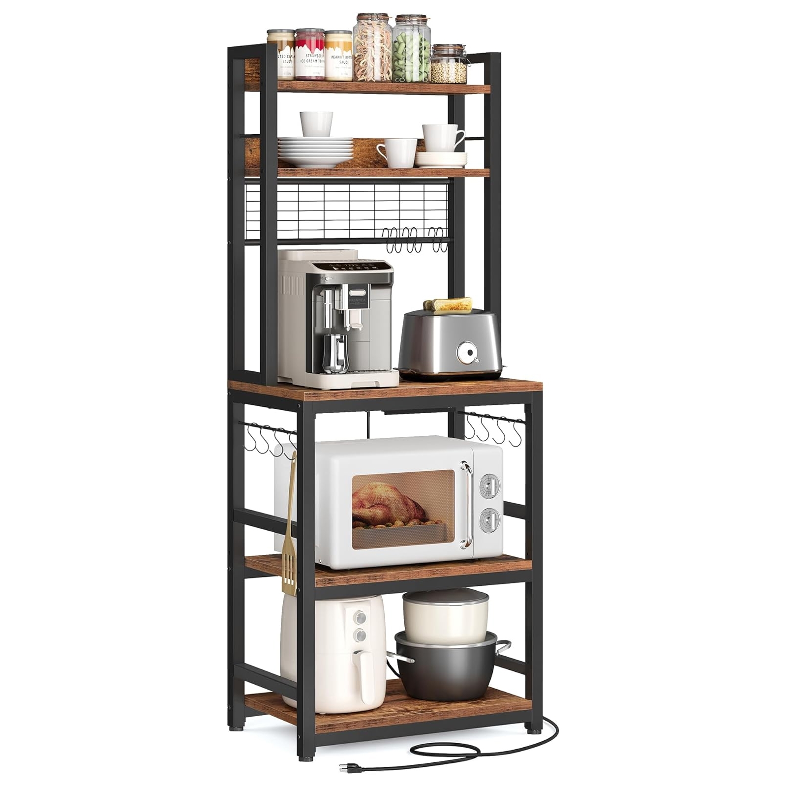 A multi-tiered metal and wood baker's rack with integrated power outlets, featuring shelves holding jars, plates, cups, a coffee machine, toaster, microwave, and cooking pots. Hooks and utensil hangers are attached to the sides.