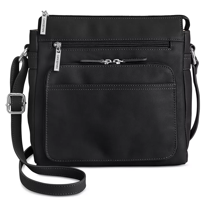 This is a black leather crossbody bag featuring multiple zippered compartments and an adjustable shoulder strap.