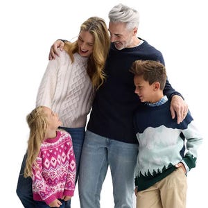 Four people are wearing casual sweaters: a woman in a white cable-knit sweater, a man in a navy sweater, a boy in a scenic landscape sweater, and a girl in a pink patterned sweater.