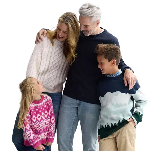 Four people are wearing casual sweaters: a woman in a white cable-knit sweater, a man in a navy sweater, a boy in a scenic landscape sweater, and a girl in a pink patterned sweater.