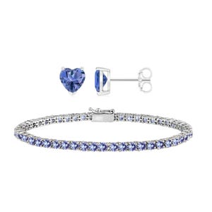 A pair of heart-shaped blue gemstone stud earrings and a tennis bracelet set with blue gemstones.