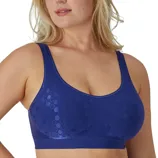 A woman is wearing a blue seamless bra with a subtle pattern of shiny circles. The bra features wide straps and offers a supportive fit.