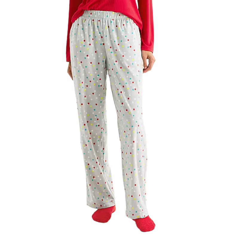 Gray pajama pants with colorful polka dots, paired with a red long-sleeve top and red socks.