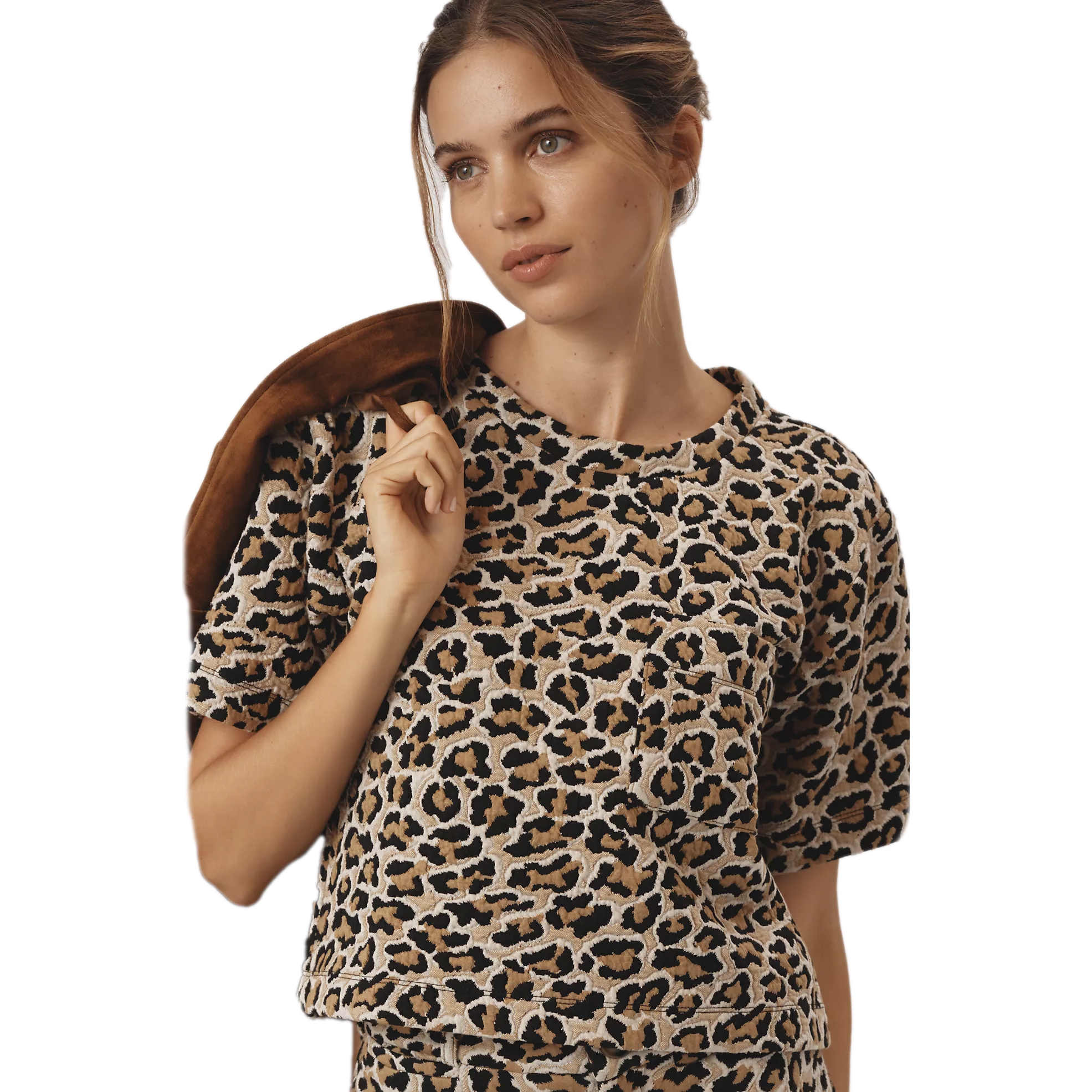 A boxy short-sleeved tee with a leopard-print pattern in shades of beige, black, and brown, featuring a relaxed fit and round neckline.