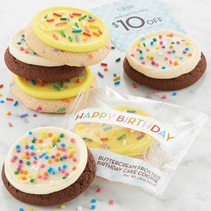Buttercream frosted birthday cake cookies with colorful sprinkles are stacked alongside a $10 off coupon from Cheryl's.