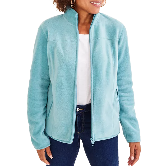 A person wearing a light blue fleece jacket with a zip-up front, paired with a white shirt and blue jeans.