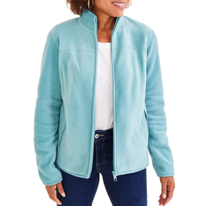 A person wearing a light blue fleece jacket with a zip-up front, paired with a white shirt and blue jeans.