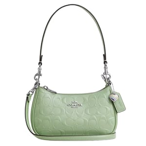 A green Coach shoulder bag with an embossed logo pattern, silver hardware, and an adjustable strap.