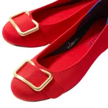 Bright red ballet flats with gold buckles.