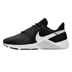 A black and white athletic shoe featuring a hexagonal pattern on the upper and a prominent white logo on the side, designed with a supportive sole for training or casual wear.