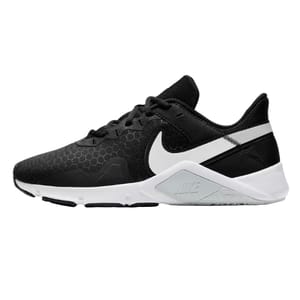 A black and white athletic shoe featuring a hexagonal pattern on the upper and a prominent white logo on the side, designed with a supportive sole for training or casual wear.
