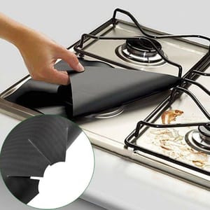 Reusable gas stovetop liners designed to protect burners from spills and stains, featuring a cut-out center for easy fit around gas burners. Easy to clean and remove, these liners keep stovetops looking tidy.