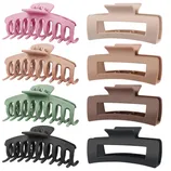 A set of four pastel and neutral-colored hair claw clips in two different shapes; curved with teeth and rectangular. Colors include pink, beige, green, and black.