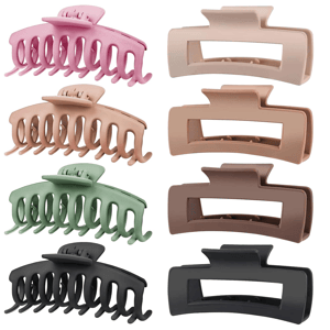 A set of four pastel and neutral-colored hair claw clips in two different shapes; curved with teeth and rectangular. Colors include pink, beige, green, and black.